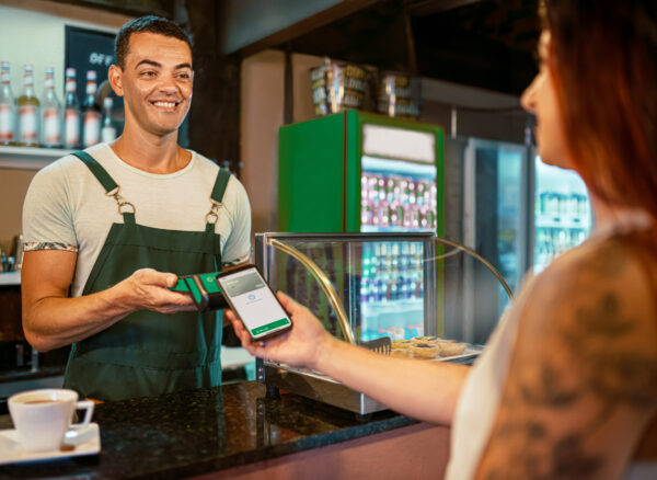 Client paying using the credit card machine in a cafeteria